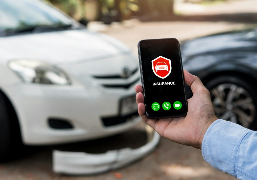 Car insurance concept.Man using phone to calling insurance agent for claim process after car crash.